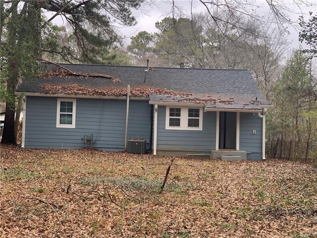 back of house with central air condition unit