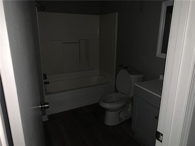 full bathroom featuring hardwood / wood-style flooring, vanity, shower / bathtub combination, and toilet