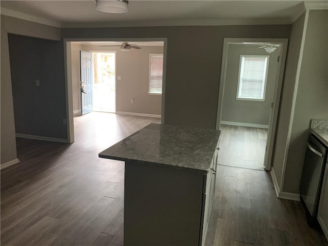 kitchen featuring hardwood / wood-style flooring, ceiling fan, a kitchen island, and a wealth of natural light