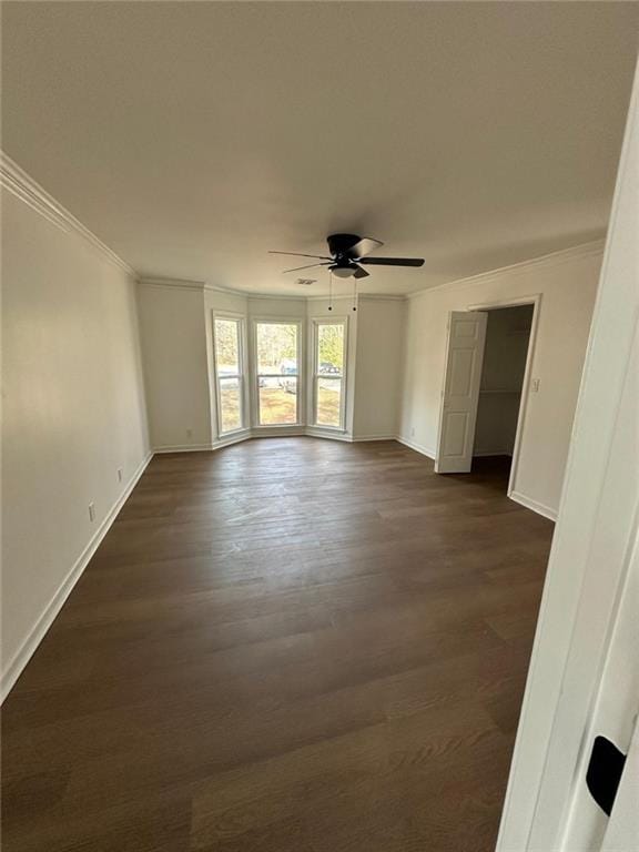 spare room featuring crown molding, ceiling fan, and dark hardwood / wood-style floors