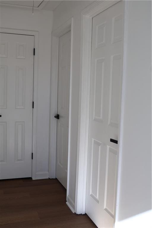 corridor with dark hardwood / wood-style flooring