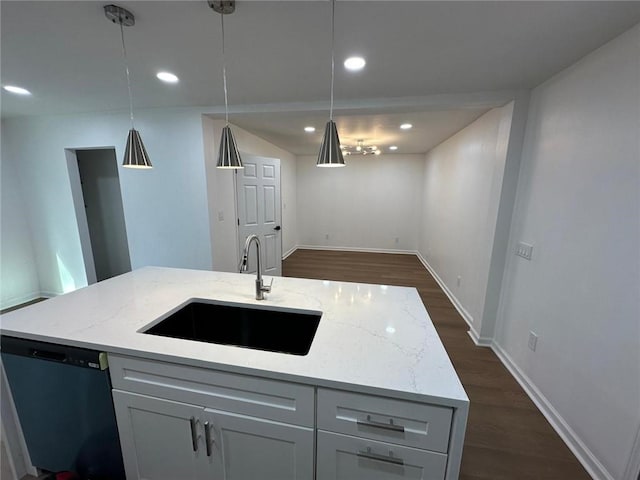 kitchen featuring sink, light stone countertops, hanging light fixtures, and dishwasher