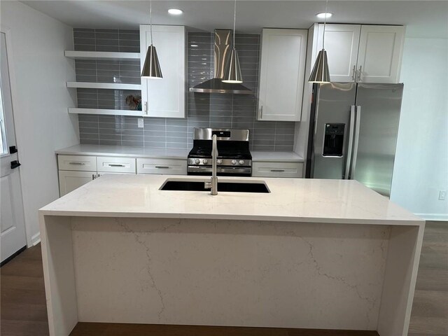 kitchen featuring stainless steel appliances, hanging light fixtures, white cabinets, and light stone counters