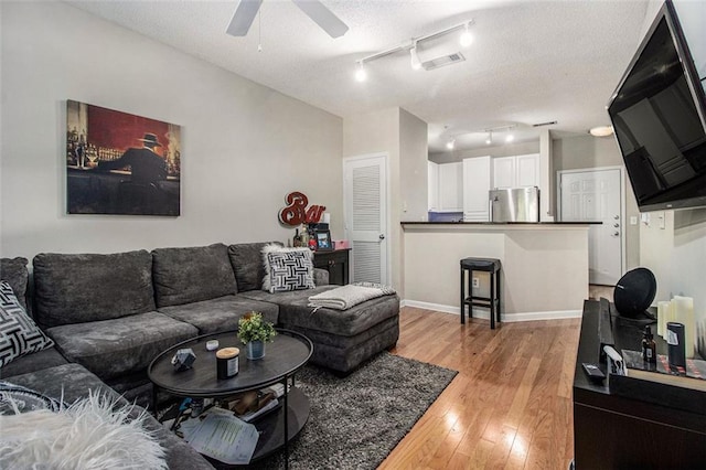 10 Perimeter Summit Blvd NE Unit 4223, Brookhaven, GA 30319 - living area featuring ceiling fan, light wood-style flooring, track lighting, and a textured ceiling