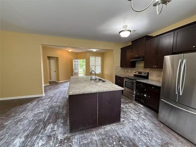 102 Daisy Cir, Mcdonough, GA 30252 - kitchen featuring appliances with stainless steel finishes, a sink, under cabinet range hood, dark wood-style floors, and decorative backsplash