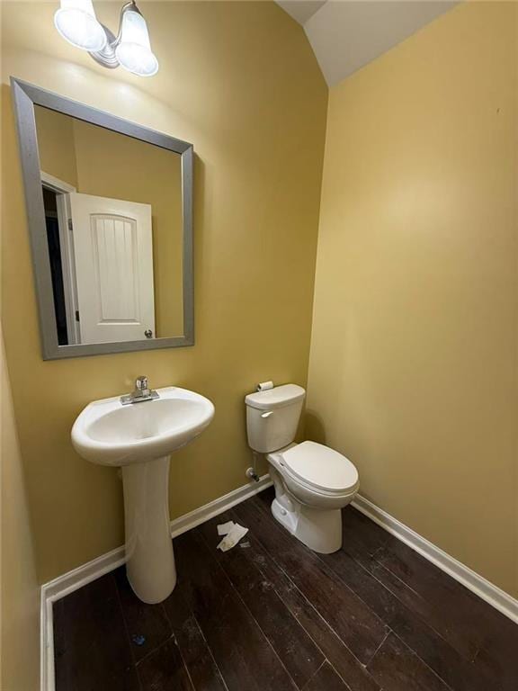 102 Daisy Cir, Mcdonough, GA 30252 - bathroom with hardwood / wood-style flooring, toilet, vaulted ceiling, baseboards, and a sink