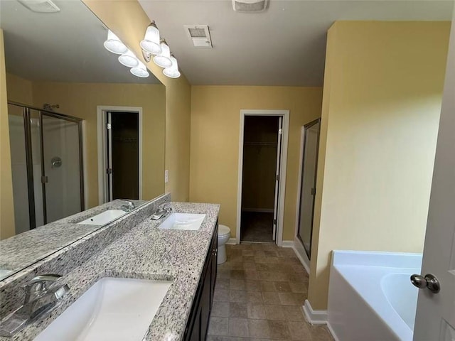 102 Daisy Cir, Mcdonough, GA 30252 - bathroom featuring a stall shower, a walk in closet, double vanity, and toilet