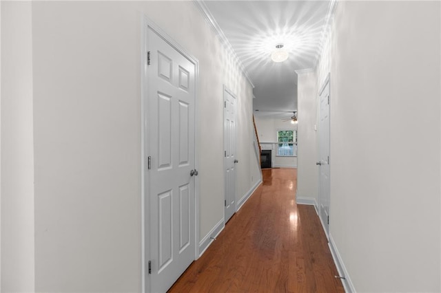 corridor featuring hardwood / wood-style floors and ornamental molding