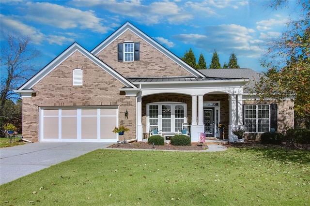 view of front of house featuring a front lawn, a garage, and a porch