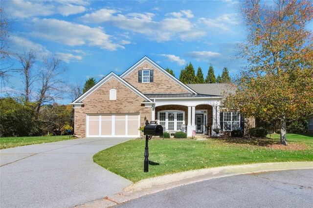 view of front facade with a garage and a front lawn