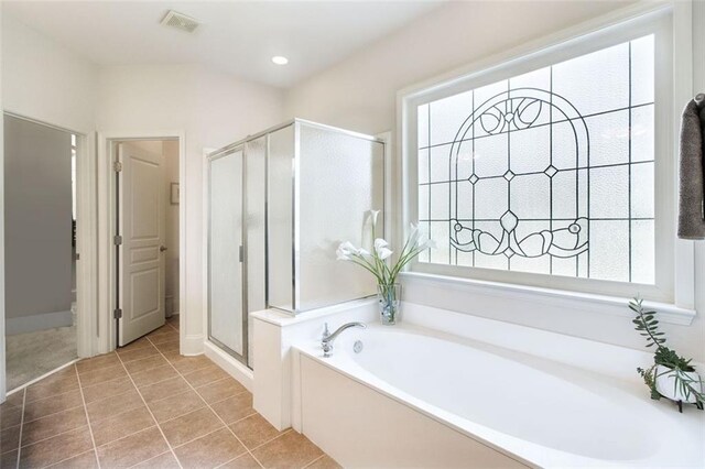 bathroom featuring tile patterned floors and separate shower and tub