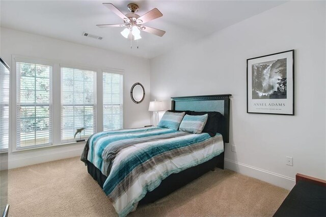 bedroom featuring ceiling fan and light colored carpet