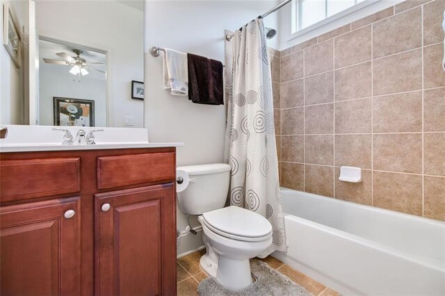 full bathroom with tile patterned floors, vanity, toilet, ceiling fan, and shower / bathtub combination with curtain