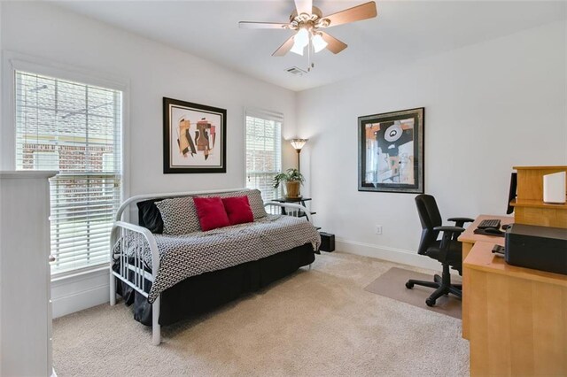 bedroom featuring light carpet and ceiling fan