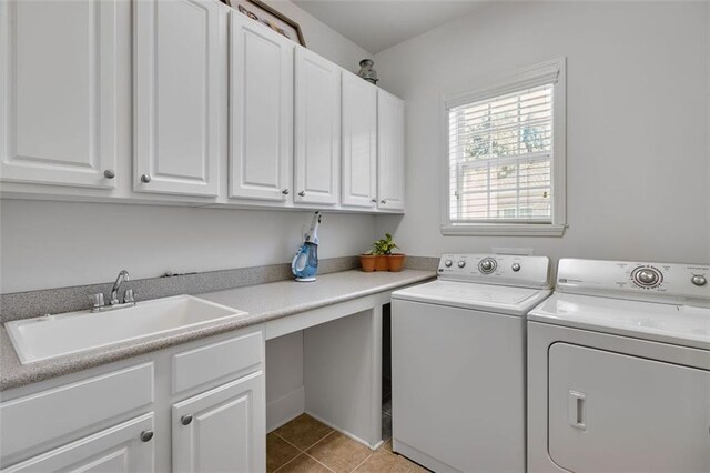 clothes washing area featuring cabinets, separate washer and dryer, sink, and light tile patterned flooring