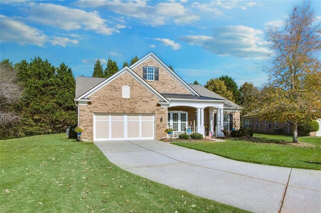 view of front of house featuring a garage and a front lawn