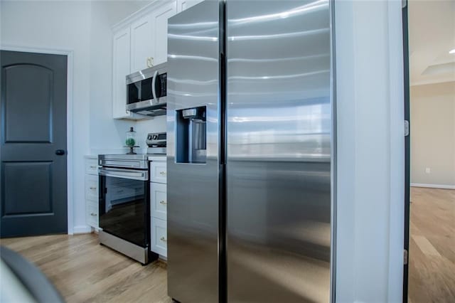 90 Ayers Rd, Bowdon, GA 30108 - kitchen with appliances with stainless steel finishes, white cabinetry, and light wood-type flooring