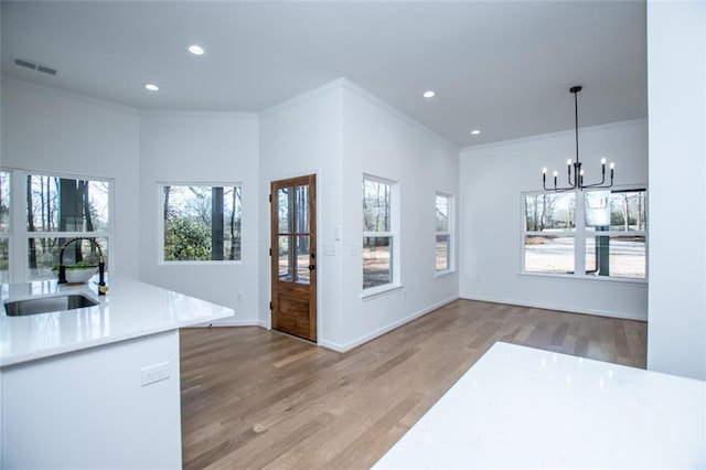90 Ayers Rd, Bowdon, GA 30108 - kitchen with a chandelier, light wood-type flooring, ornamental molding, recessed lighting, and light countertops