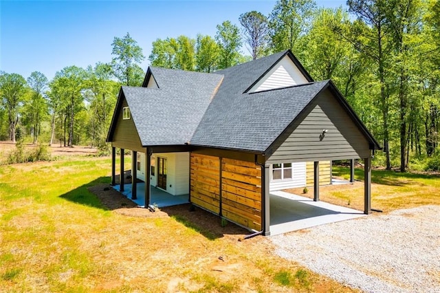 90 Ayers Rd, Bowdon, GA 30108 - view of side of property featuring driveway, roof with shingles, a carport, and a yard