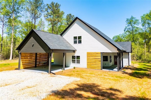 90 Ayers Rd, Bowdon, GA 30108 - rear view of house with driveway, a shingled roof, and a carport
