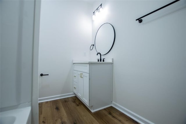 90 Ayers Rd, Bowdon, GA 30108 - bathroom featuring wood finished floors, vanity, and a bath