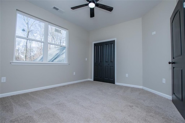 90 Ayers Rd, Bowdon, GA 30108 - unfurnished bedroom featuring carpet, a ceiling fan, and a closet