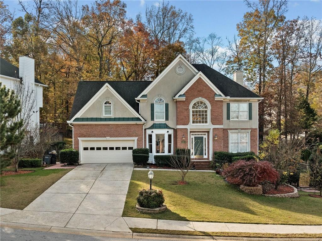 view of front of home featuring a garage and a front lawn