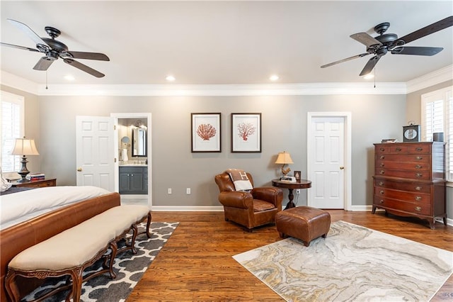 bedroom with crown molding, recessed lighting, ensuite bathroom, wood finished floors, and baseboards