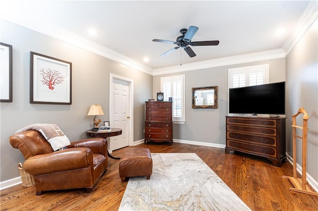 sitting room with baseboards, ornamental molding, and wood finished floors