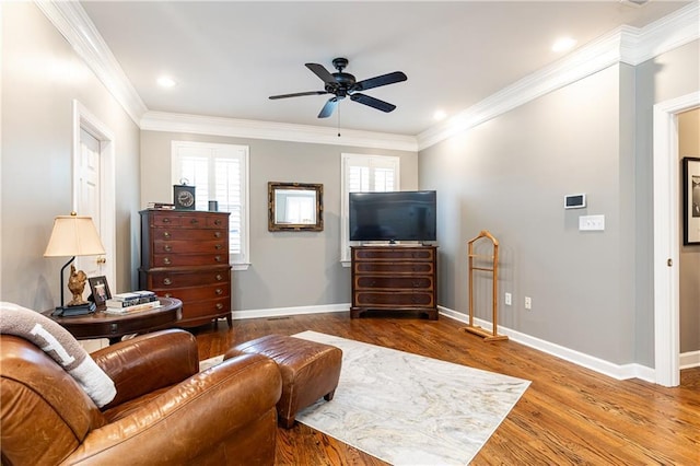 living room with a ceiling fan, baseboards, ornamental molding, and wood finished floors