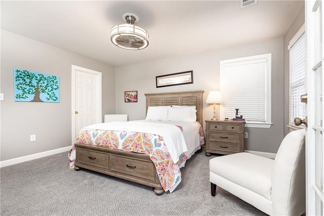 bedroom featuring carpet floors, visible vents, and baseboards