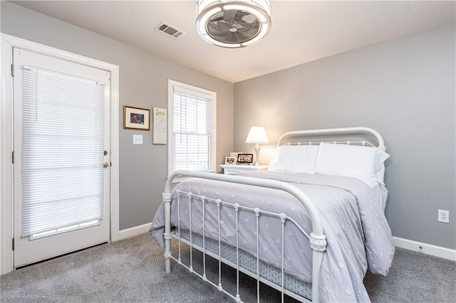 bedroom featuring carpet floors, visible vents, and baseboards