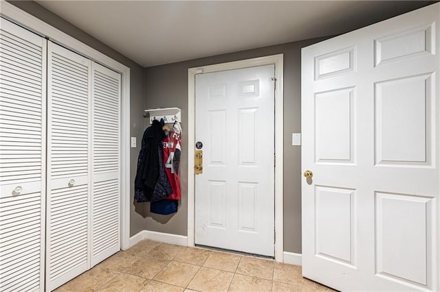 entrance foyer featuring baseboards and light tile patterned floors