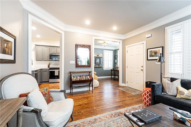 living room with light wood-type flooring, crown molding, baseboards, and recessed lighting