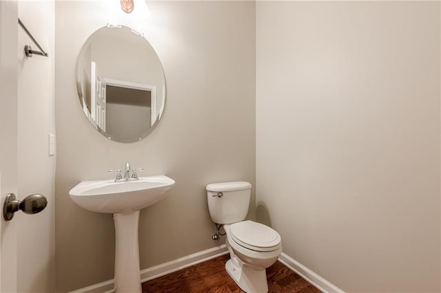 4404 Village Field Pl, Suwanee, GA 30024 - half bathroom featuring baseboards, toilet, and wood finished floors
