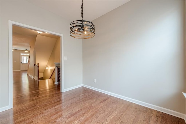 4404 Village Field Pl, Suwanee, GA 30024 - unfurnished room featuring light wood-type flooring, a chandelier, and baseboards