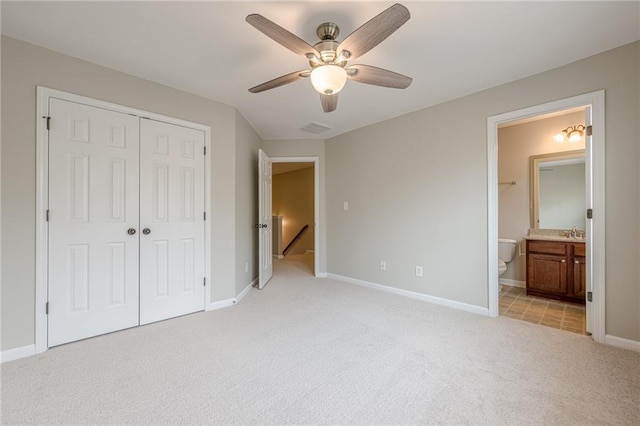 4404 Village Field Pl, Suwanee, GA 30024 - unfurnished bedroom featuring light carpet, a closet, baseboards, a ceiling fan, and ensuite bathroom