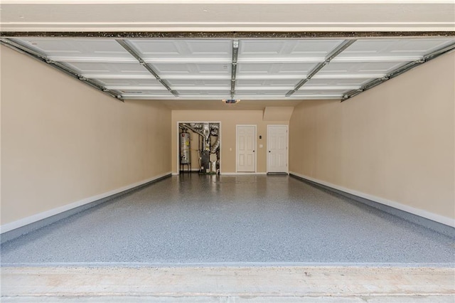 4404 Village Field Pl, Suwanee, GA 30024 - garage featuring gas water heater, baseboards, and a garage door opener