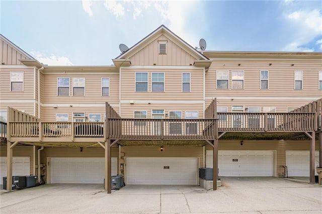 4404 Village Field Pl, Suwanee, GA 30024 - rear view of house with board and batten siding, a garage, and driveway