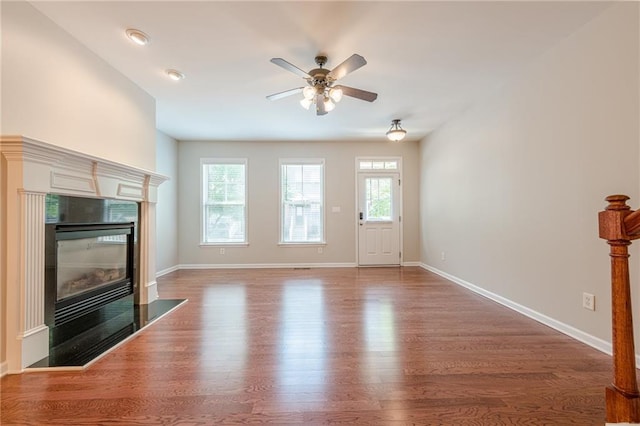 4404 Village Field Pl, Suwanee, GA 30024 - unfurnished living room with wood finished floors, a ceiling fan, a premium fireplace, and baseboards