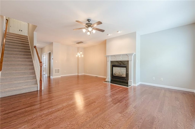 4404 Village Field Pl, Suwanee, GA 30024 - unfurnished living room featuring a ceiling fan, stairway, wood finished floors, and baseboards