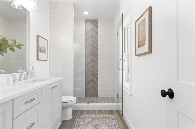 3317 Stillwood Ln, Hapeville, GA 30354 - bathroom with a stall shower, vanity, toilet, and wood tiled floor