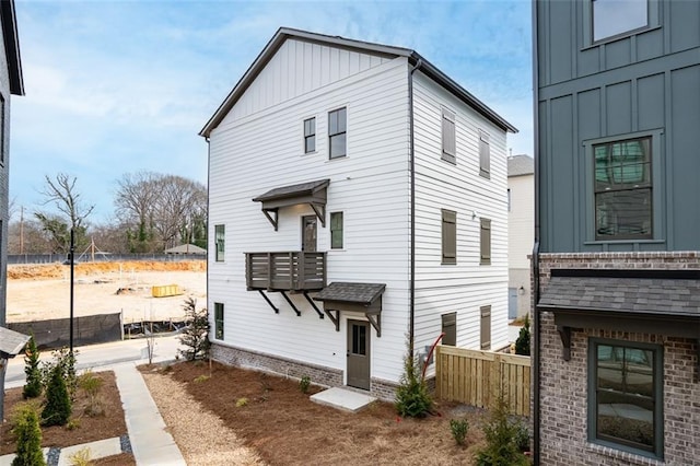 3317 Stillwood Ln, Hapeville, GA 30354 - view of front of home with board and batten siding, brick siding, and fence