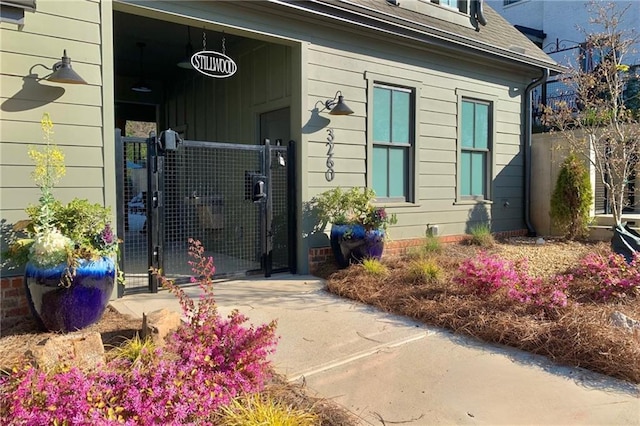 3317 Stillwood Ln, Hapeville, GA 30354 - property entrance with a shingled roof, a gate, and fence