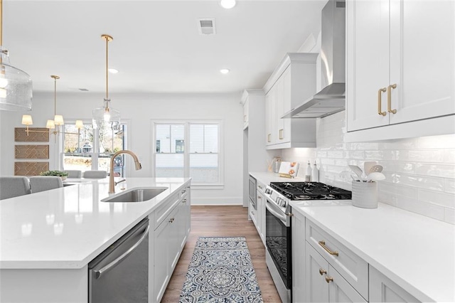3317 Stillwood Ln, Hapeville, GA 30354 - kitchen featuring visible vents, stainless steel dishwasher, wall chimney range hood, a sink, and gas stove