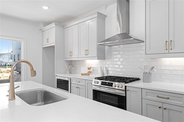 3317 Stillwood Ln, Hapeville, GA 30354 - kitchen featuring wall chimney exhaust hood, built in microwave, light countertops, a sink, and gas stove