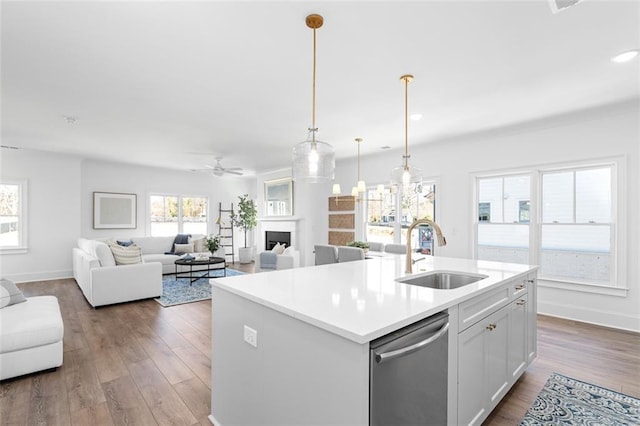3317 Stillwood Ln, Hapeville, GA 30354 - kitchen with a sink, a fireplace, stainless steel dishwasher, and wood finished floors
