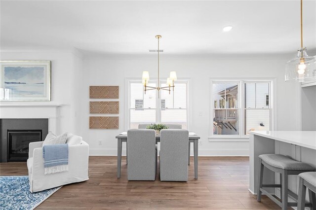 3317 Stillwood Ln, Hapeville, GA 30354 - dining area featuring visible vents, a glass covered fireplace, wood finished floors, a chandelier, and baseboards