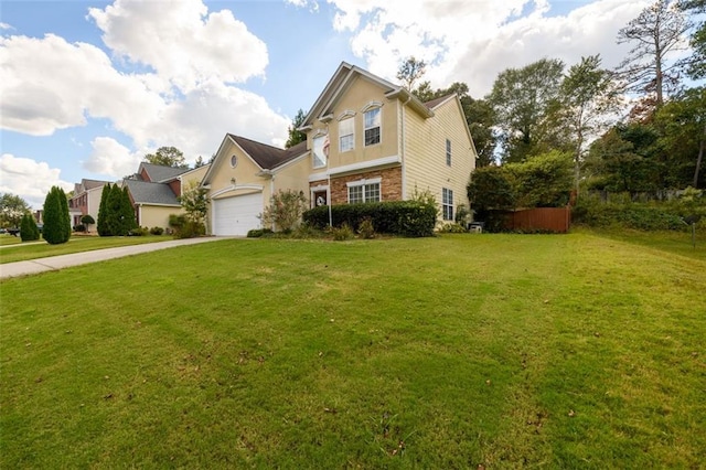 view of front property featuring a garage and a front yard