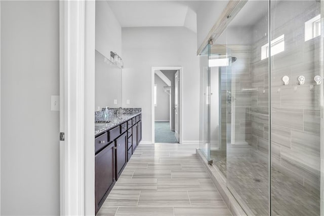 3259 Ivy Crossing Dr, Buford, GA 30519 - bathroom featuring a stall shower, double vanity, and baseboards